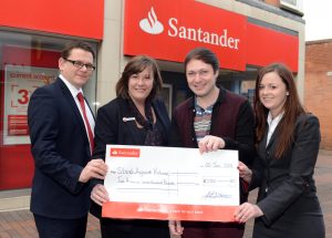 Santander employees and SAV founder with match funding cheque